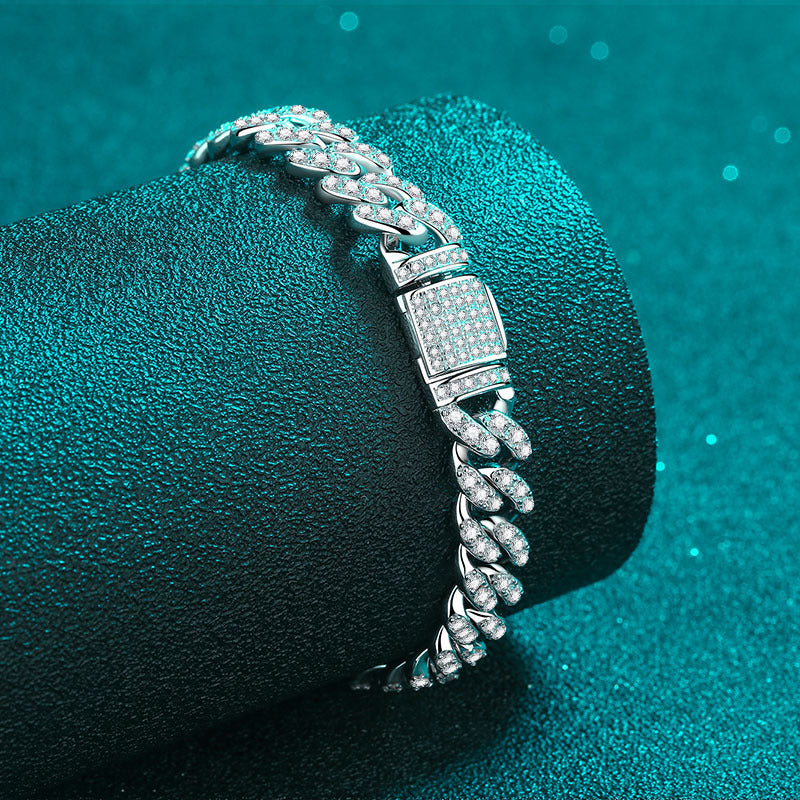Silver bracelet with diamond accents on a teal background