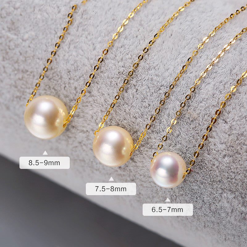 Three pearl necklaces with different pearl sizes on a textured surface