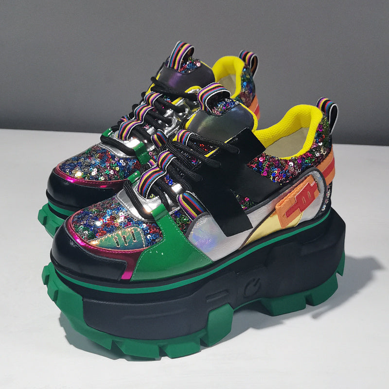 Colorful platform sneakers with glittery details on a gray background