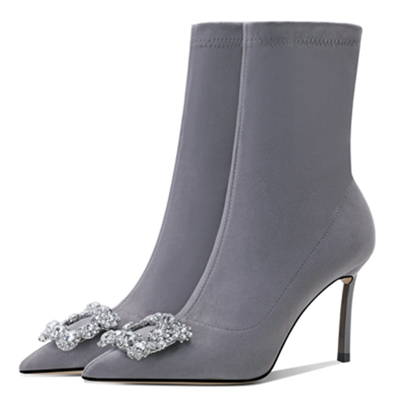 Gray high-heeled boots with decorative elements on a white background