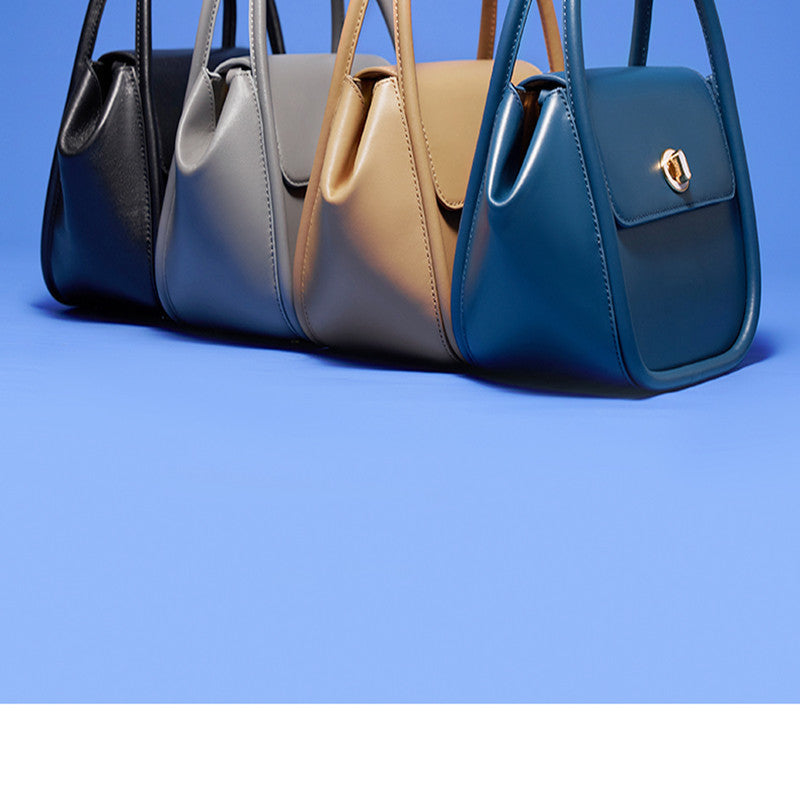 Three handbags in black, beige, and blue on a blue background