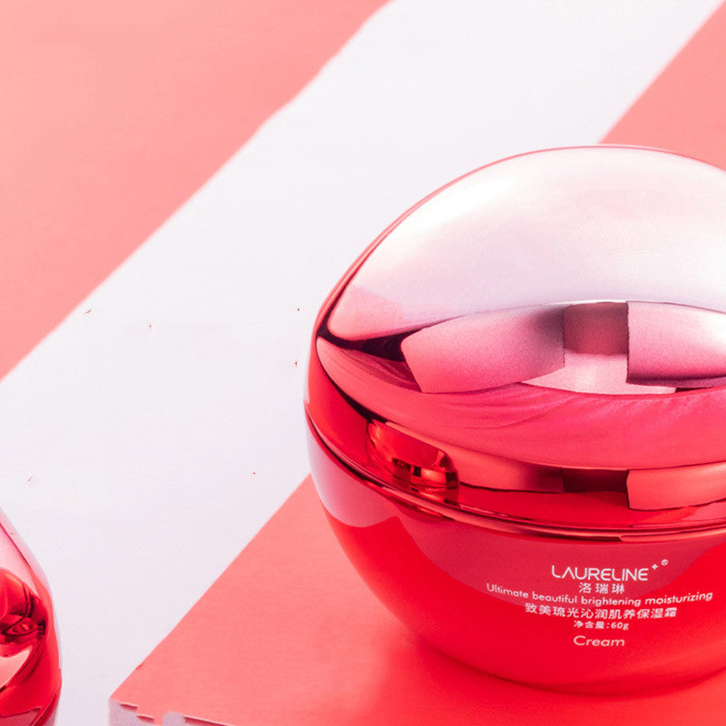 Red cosmetic jar with white cap on a pink and white geometric background
