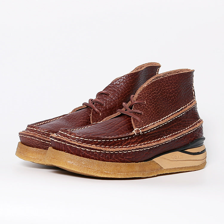 Brown leather shoes with a beige sole on a white background