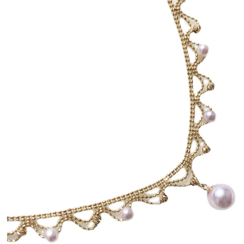 Gold necklace with pearls on a white background