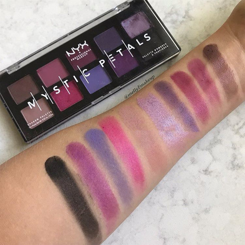 NYX Professional Makeup Mystic Petals palette with swatches on a arm against a marble background