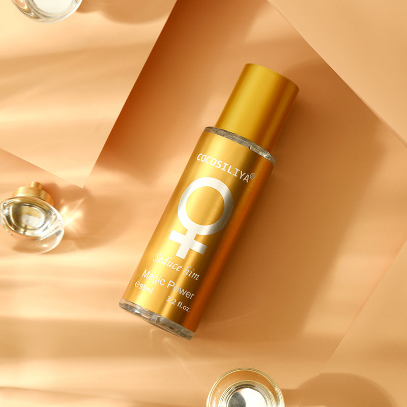 Gold bottle with a logo on a peach-colored background