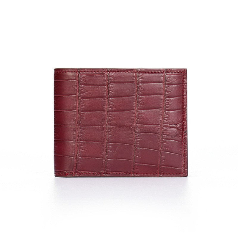 Red leather wallet with crocodile texture on a white background