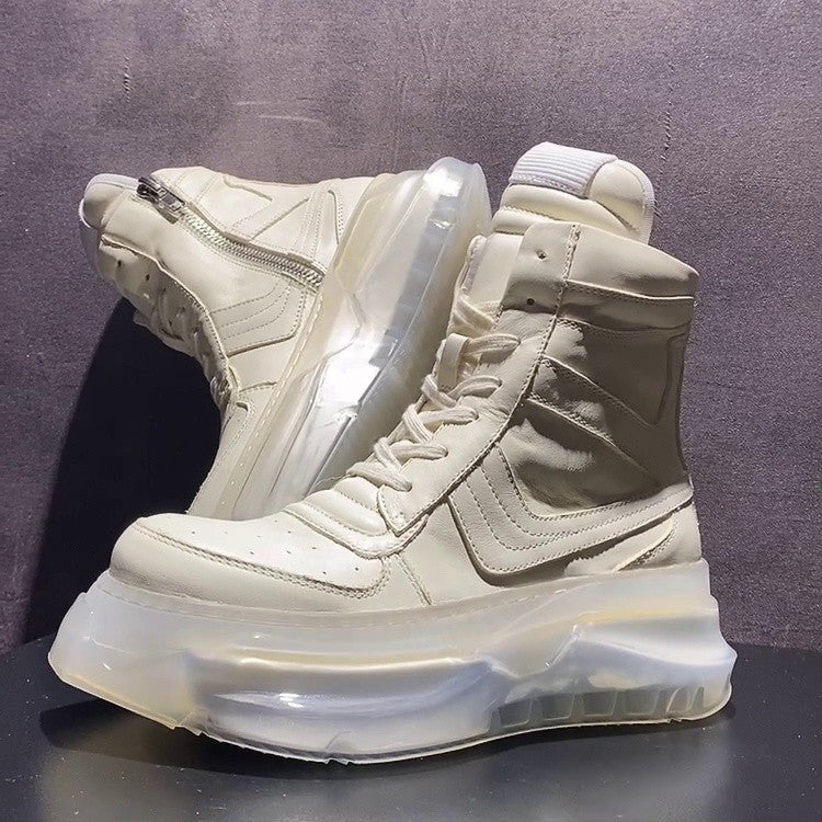 White high-top sneakers with transparent sole on a dark surface and gray background