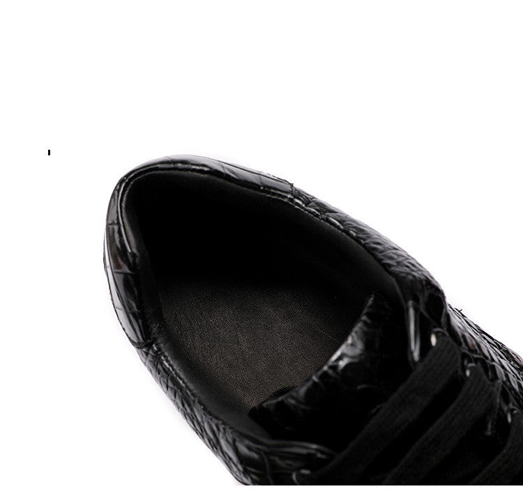Black leather shoe with a textured pattern on a white background