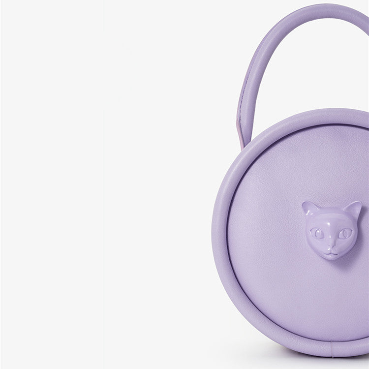 Purple round container with a cat face design on a white background