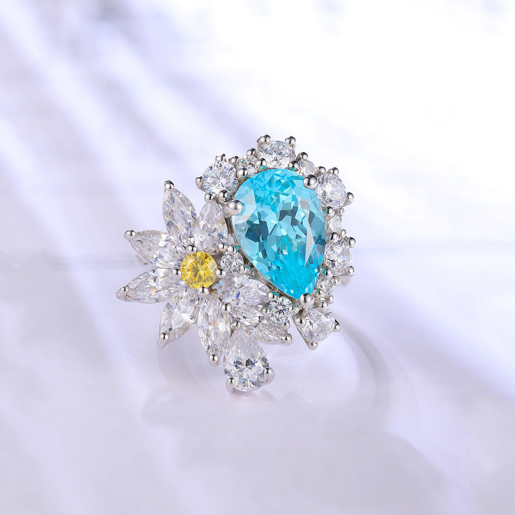 Jewelry with a blue gemstone and yellow gemstone on a white background