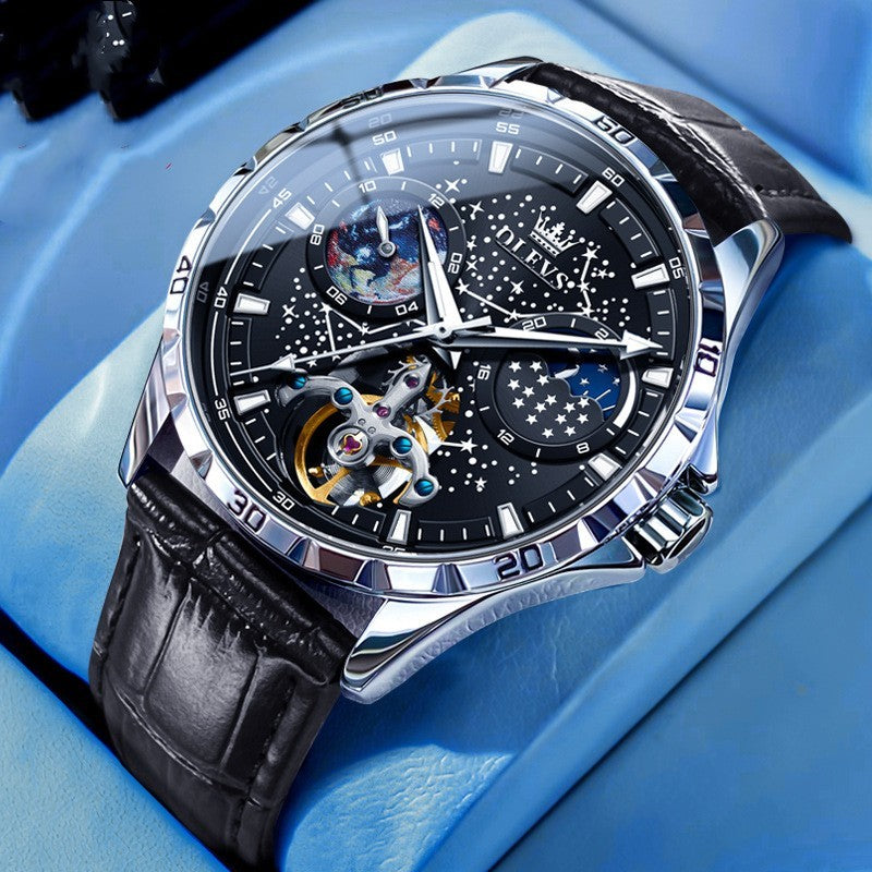 Luxury watch with black leather strap and intricate design on a blue background
