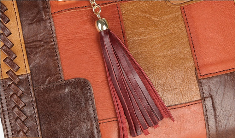 Close-up of a leather bag with a tassel detail