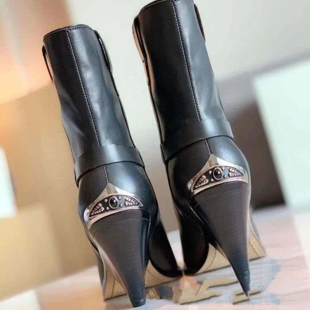 Black high-heeled boots with decorative metal accents on a blurred background