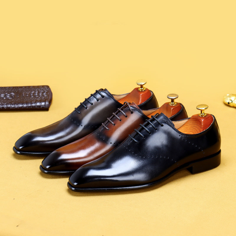 Three pairs of polished dress shoes in black, brown, and red on a yellow background.