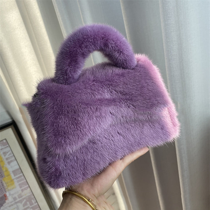 Purple fluffy handbag held in front of a light curtain