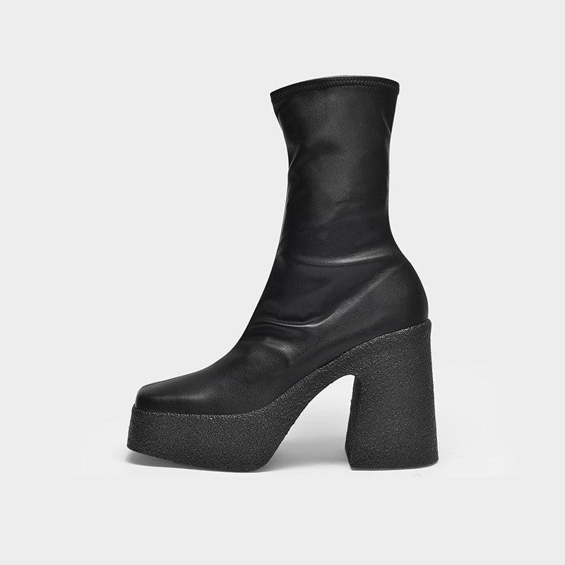 Black platform ankle boot on a light gray background