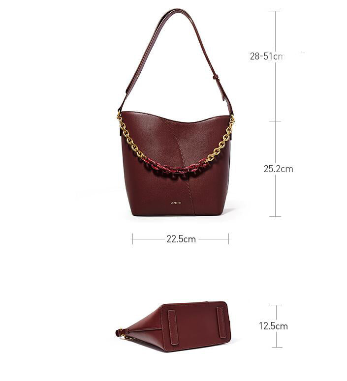 Maroon handbag with gold chain detail and dimensions on a white background