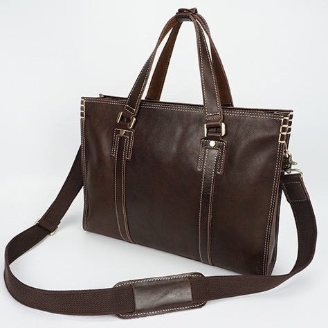 Brown leather handbag with a shoulder strap on a white background