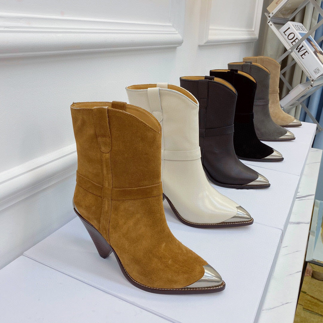 Row of women's boots with metallic toes on a white surface.