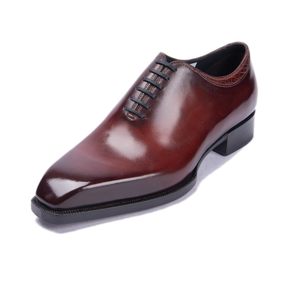 Brown leather dress shoe on a white background