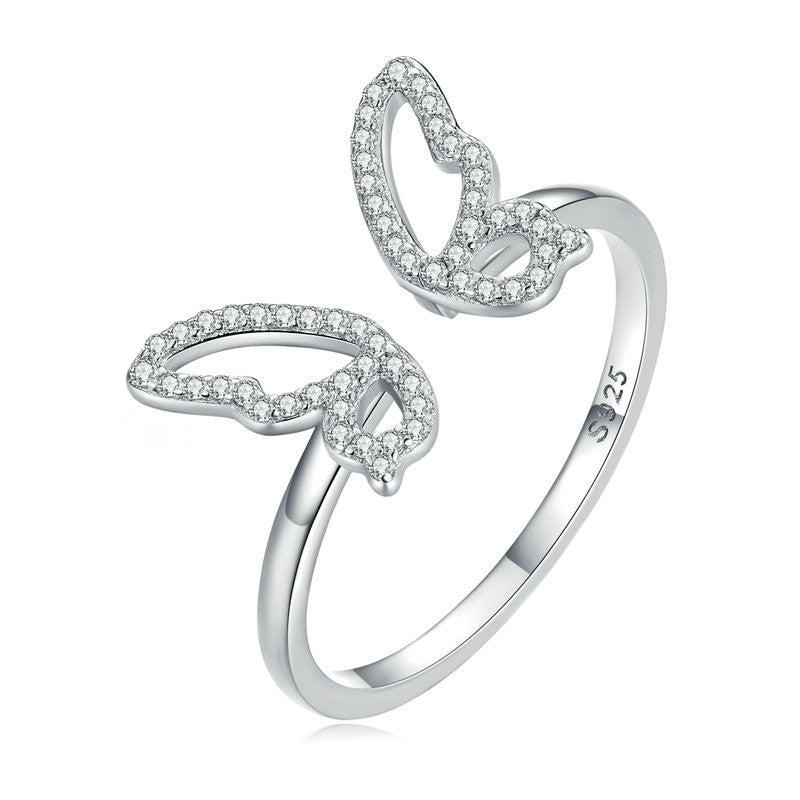 Silver snake-shaped ring with diamond accents on a white background