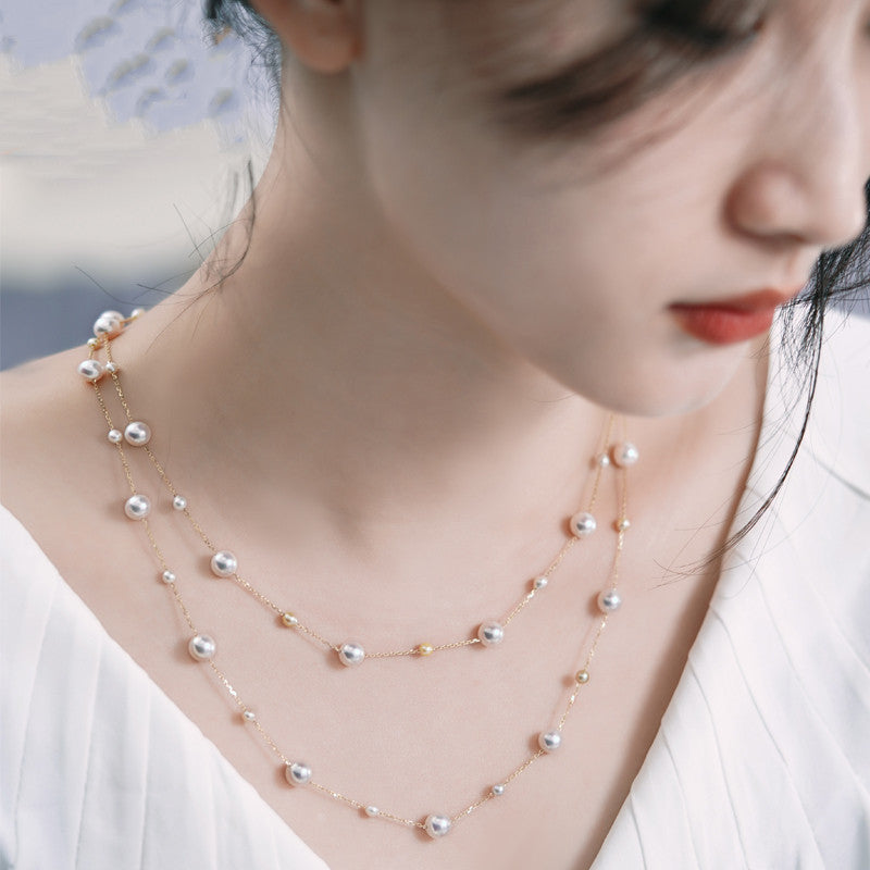 Woman wearing a pearl necklace with a blurred background