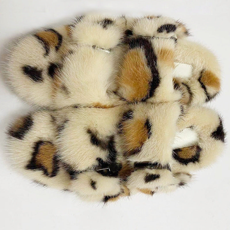 Stack of fluffy animal print slippers on a white background