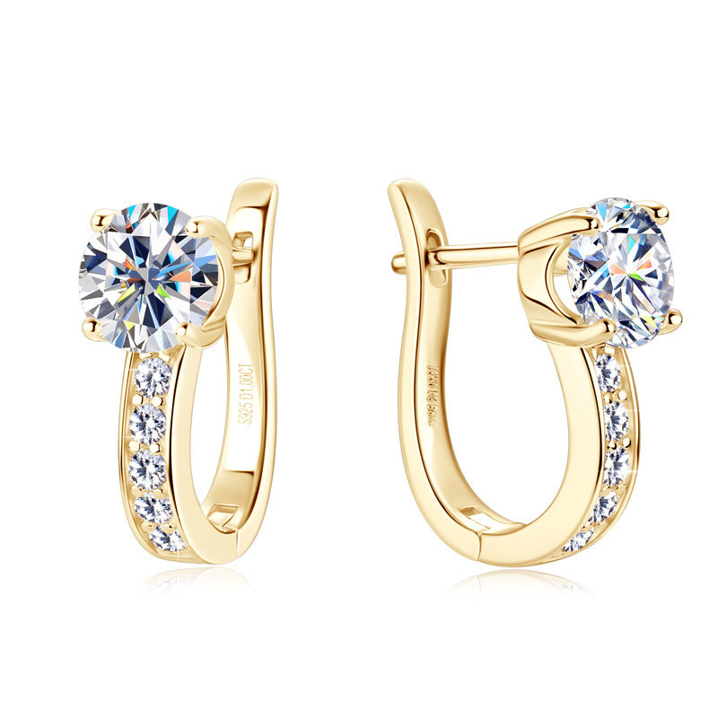 Gold hoop earrings with clear gemstones on a white background