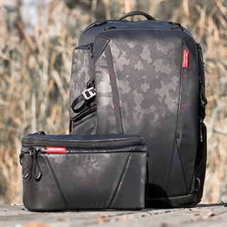 Black backpack with camouflage pattern on a wooden surface