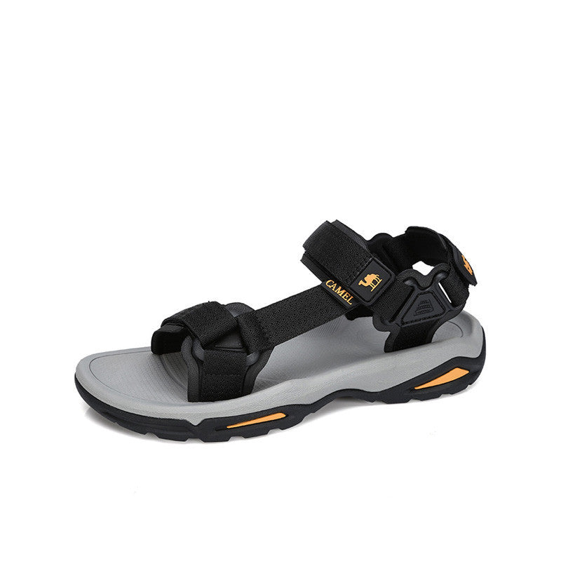 Black and gray sandal with orange accents on a white background