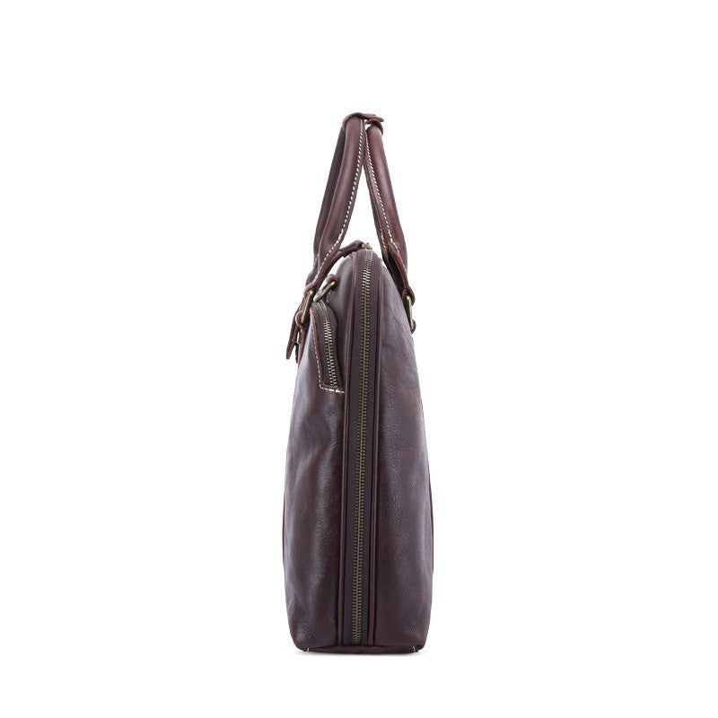 Brown leather briefcase with shoulder strap on a white background