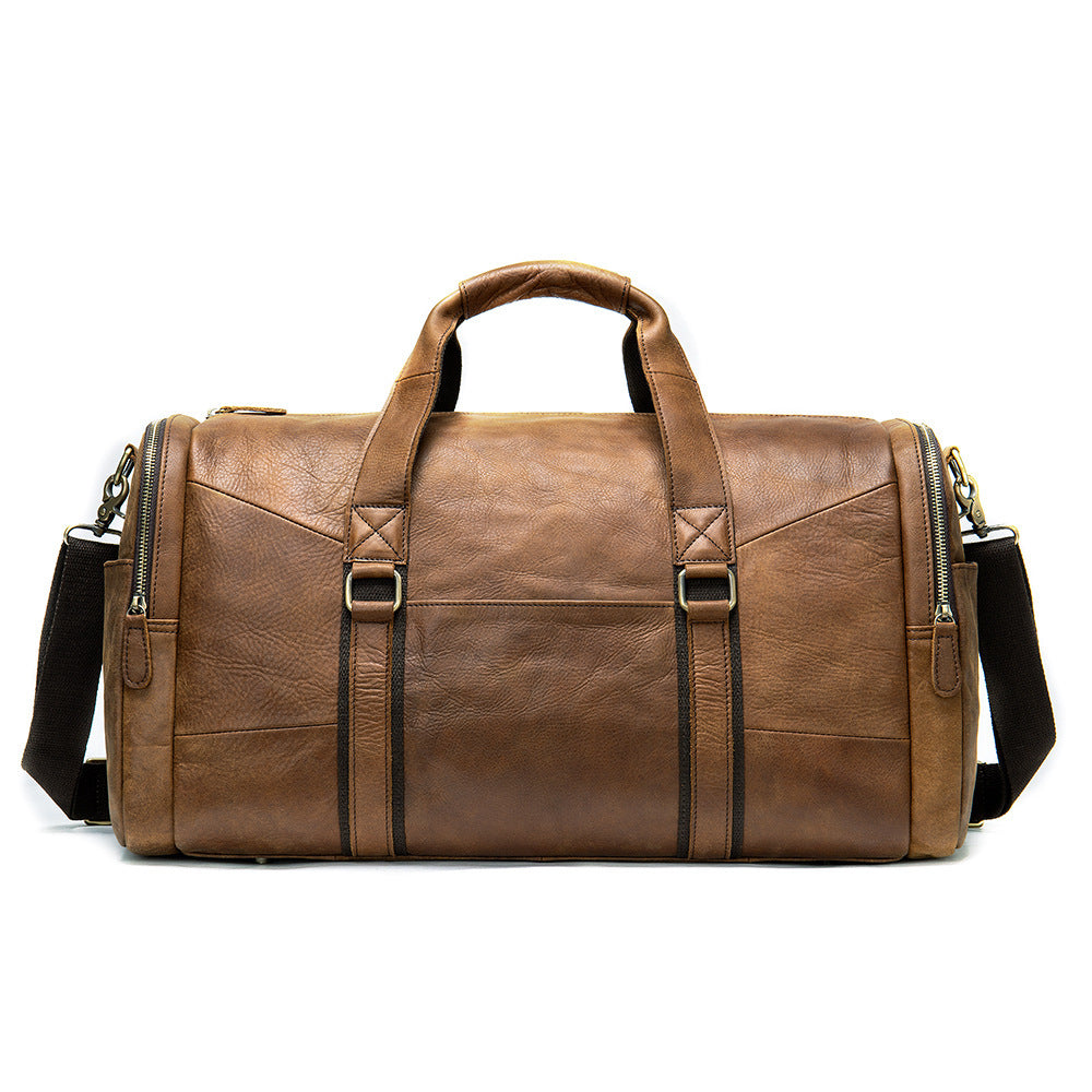 Brown leather duffel bag with shoulder strap on a white background