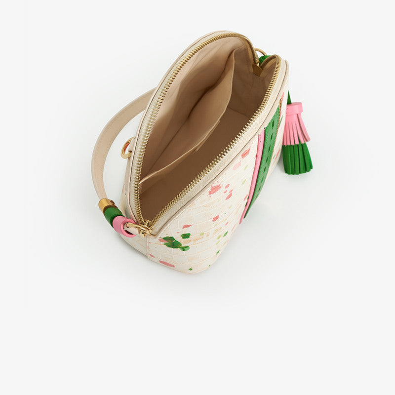 Small pouch with floral pattern and tassel on a white background