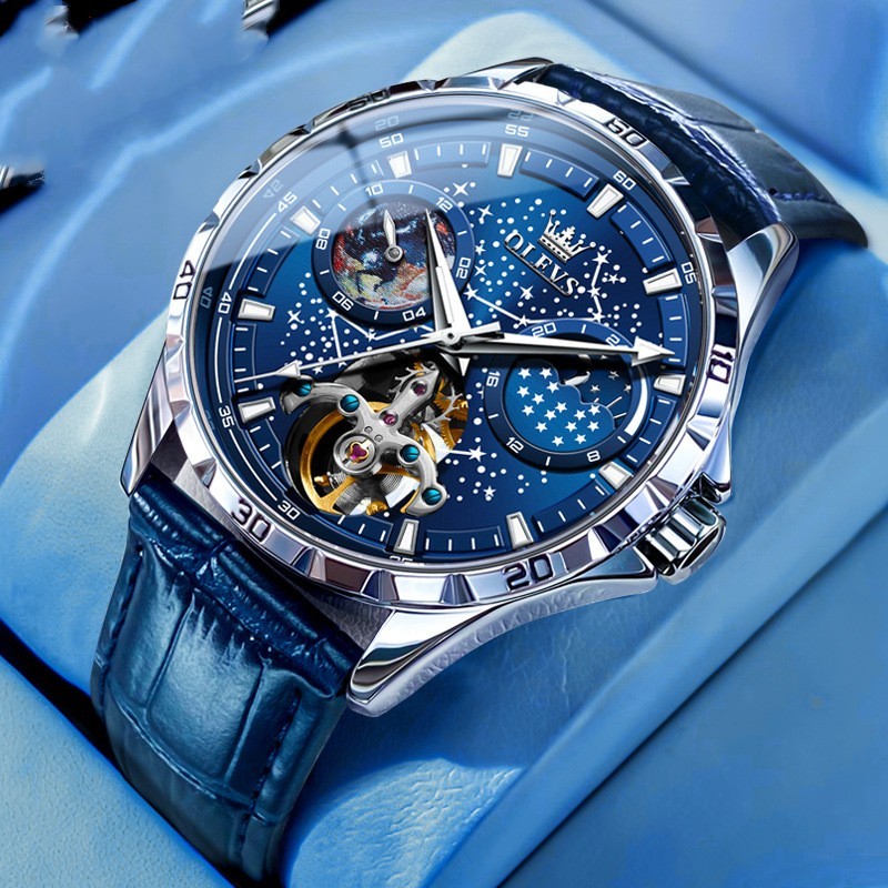 Luxury watch with blue face and leather strap on a blue background