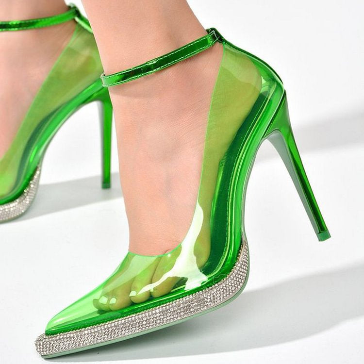 Green high-heeled shoes with clear design and rhinestone details on a white background