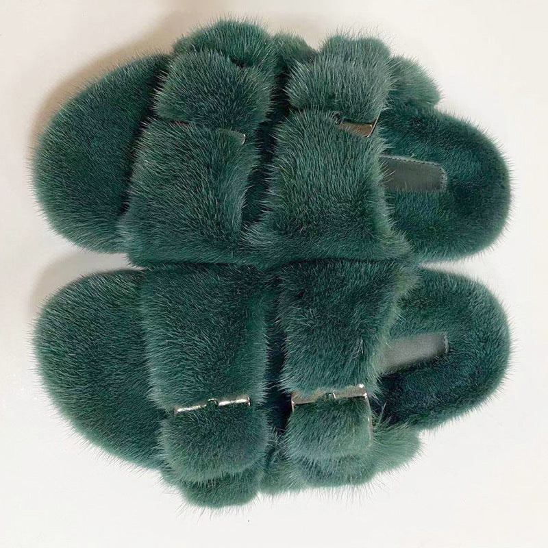 Set of green faux fur hair clips on a white background