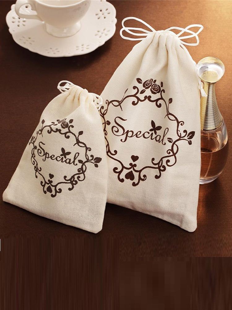 Two white drawstring bags with 'Special' text on a wooden surface.