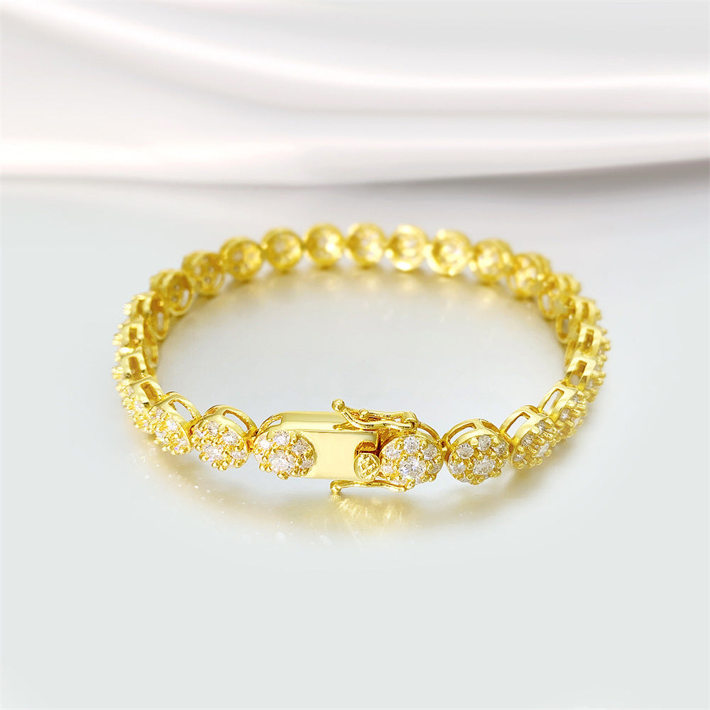 Gold bracelet with diamond accents on a white background