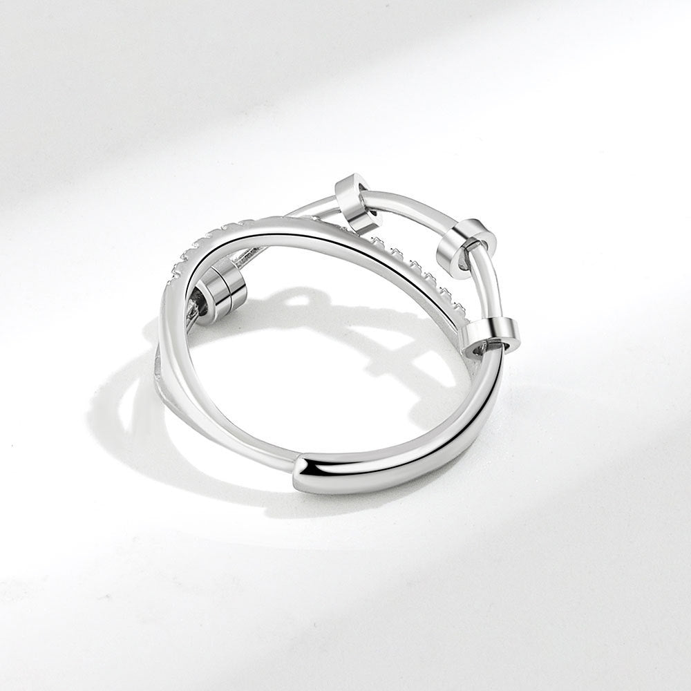 Silver hoop earring on a light gray background