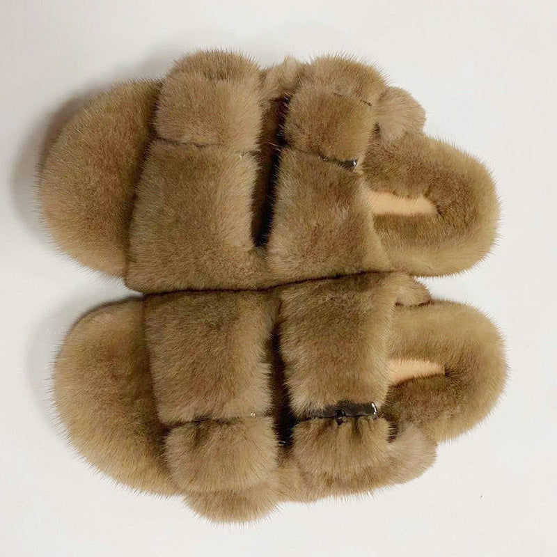 Pair of brown fuzzy slippers on a white background