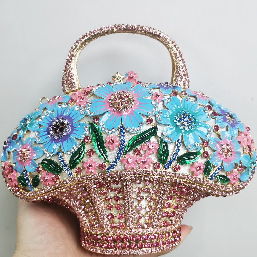 Decorative handbag with floral design and rhinestones on a light gray background