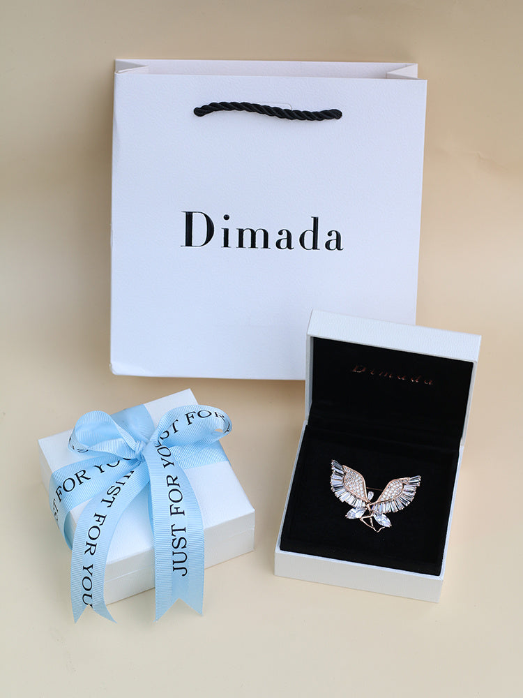 Jewelry set with 'Dimada' branded box on a beige background