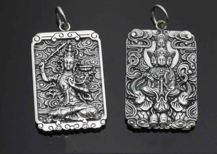 Two silver pendants with intricate designs on a dark background
