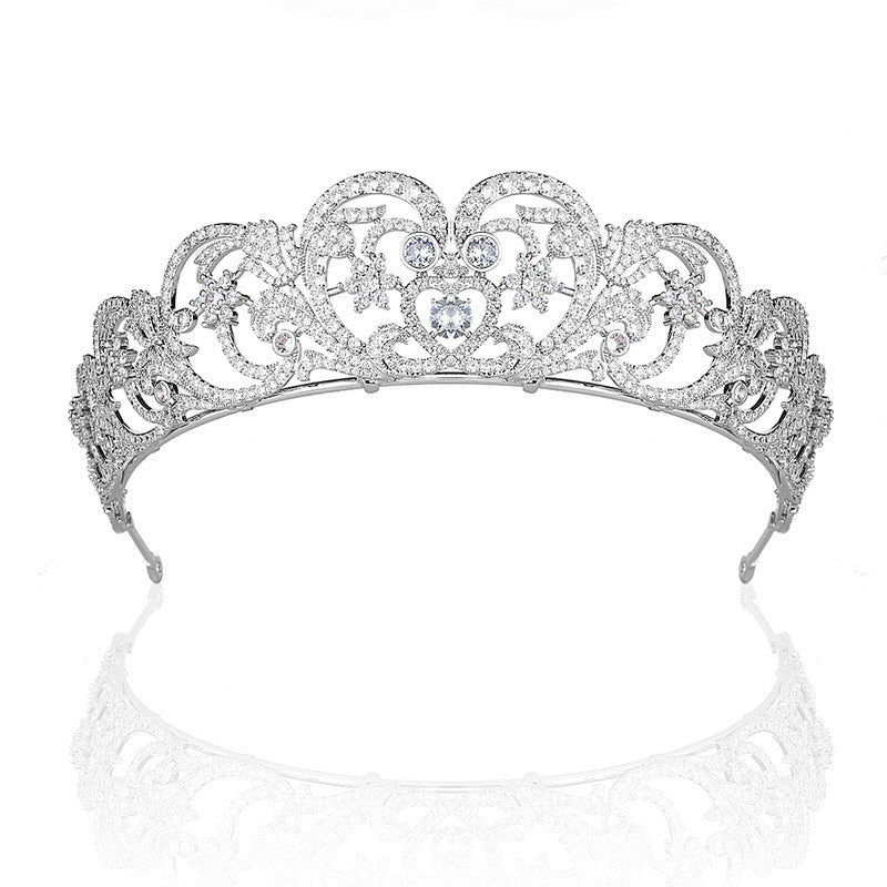 Silver tiara with intricate design on a white background