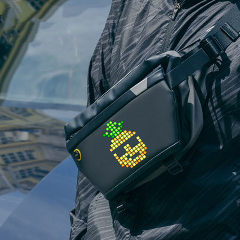 Person wearing a black fanny pack with a pixelated pineapple design in an urban setting.