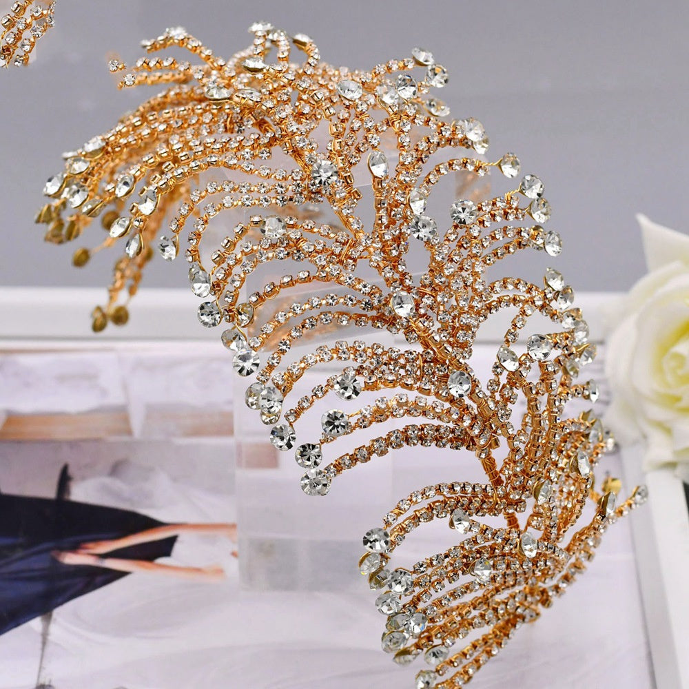 Gold and silver decorative headpiece on a stand with a blurred background