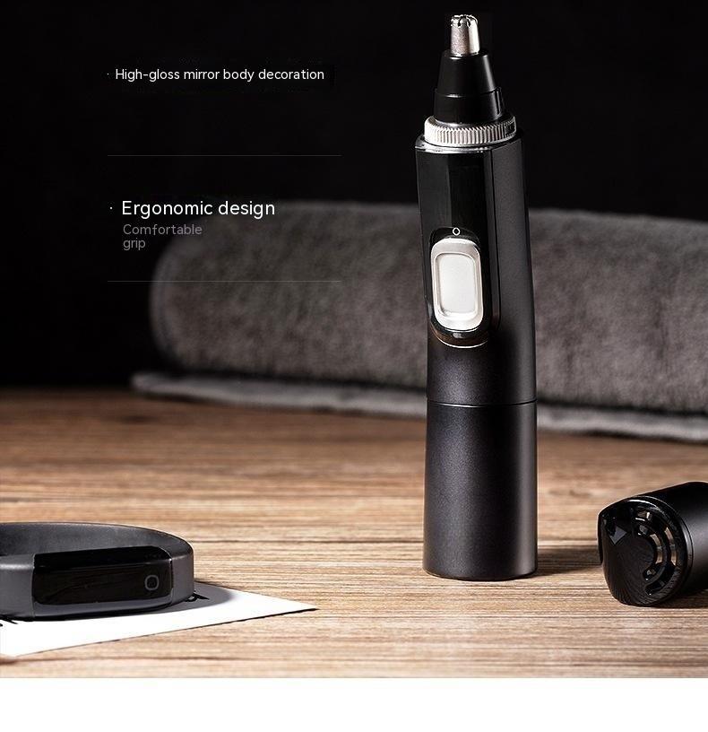 Black nose hair trimmer on a wooden surface with text describing features.