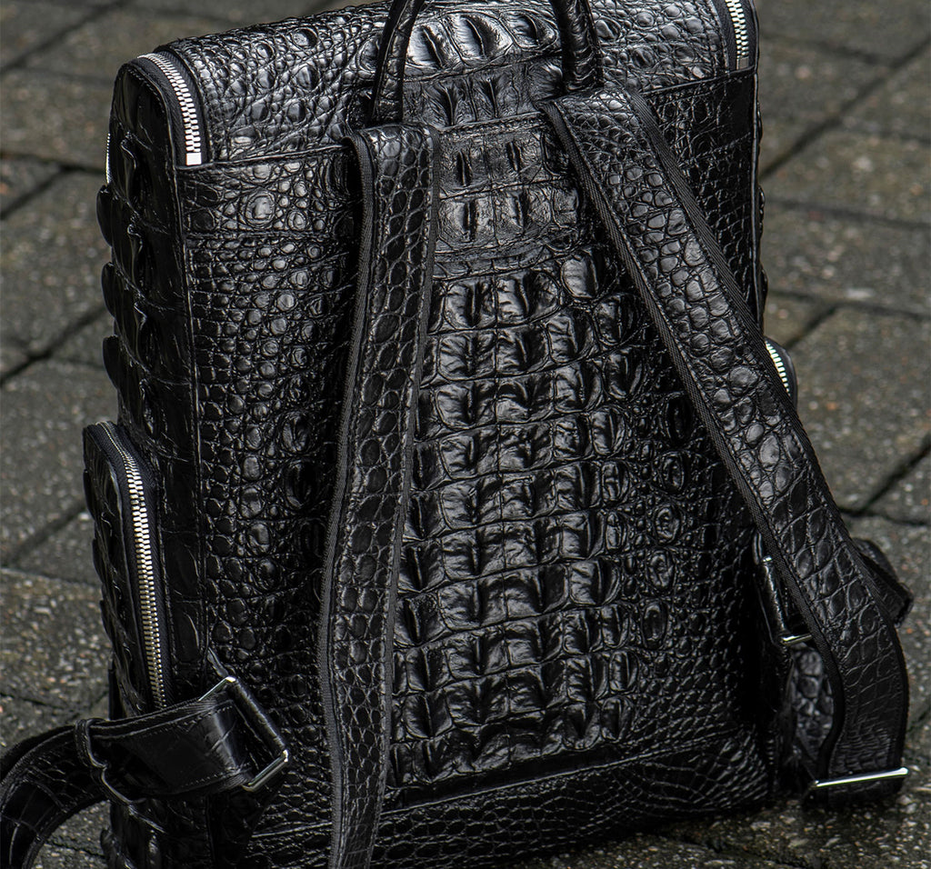 Black textured backpack on a textured surface