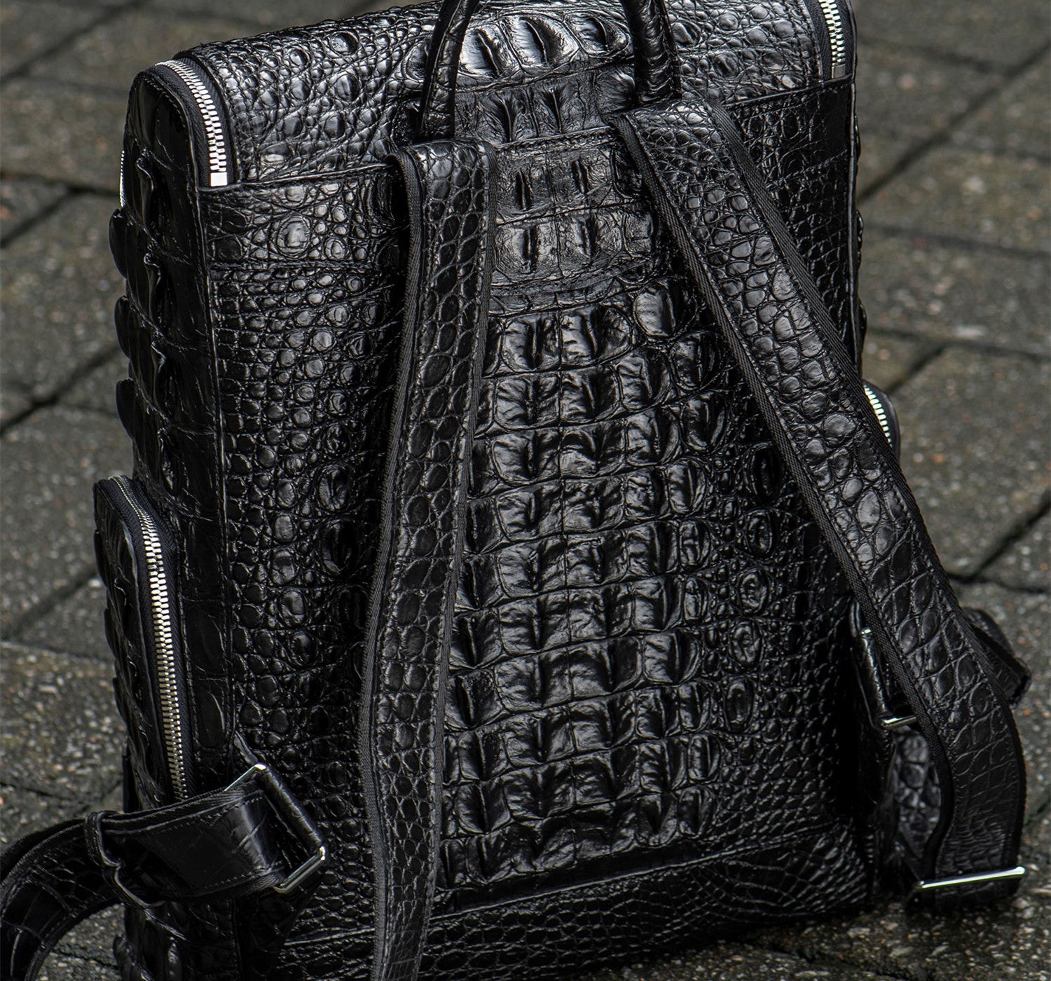 Black textured backpack on a textured surface